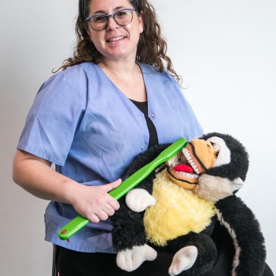 Dentist demonstrating toothbrush on stuffed animal 4