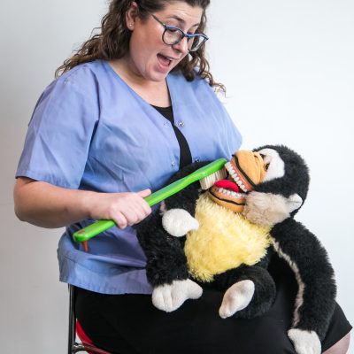 Dentist demonstrating toothbrush on stuffed animal 5