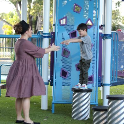 Mother and Young Boy Enjoying Outdoor Playground Activities