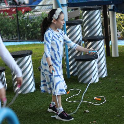 Young Girl Jumping Rope at an Outdoor Playground