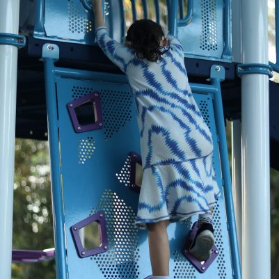 Active Young Girl Climbing at a Playground