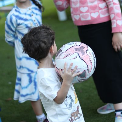 Young Boy Holding a Ball