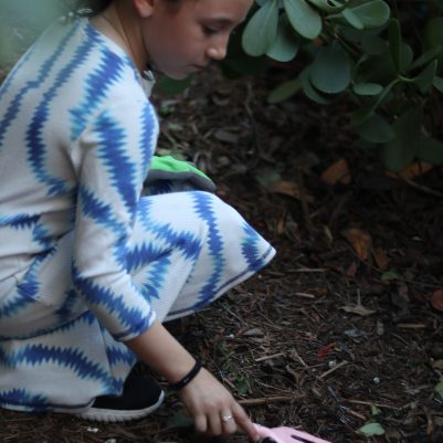 Young Girl Exploring Nature While Gardening
