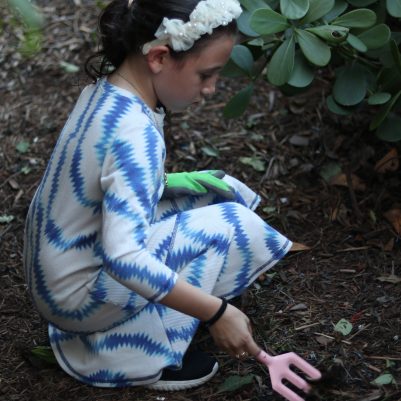 Focused Young Girl Gardening and Exploring Soil