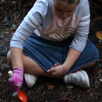 Focused Child Gardening and Exploring Soil