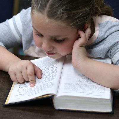 Young Girl Reading with Focus and Concentration