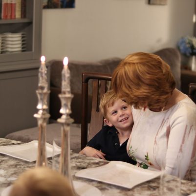 Grandmother and Smiling Grandson Seated Together at the Family Table
