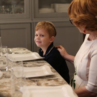 Smiling Young Man Spending Time with His Grandparents Before Dinner