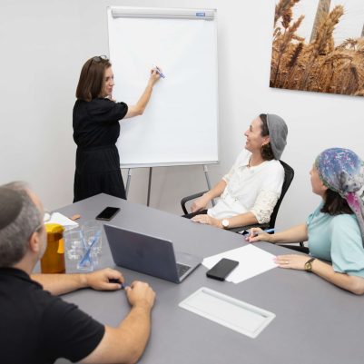 Professional Woman Presenting Strategic Project Updates to her Team