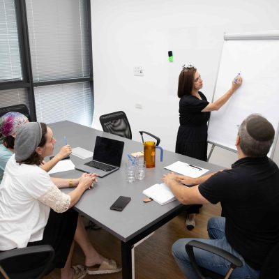 Business Woman Presenting Project Updates to Her Team