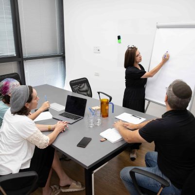 Business Woman Presenting Project Updates to Her Team