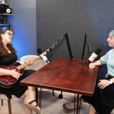 Podcast and Music Recording Session with Two Women Using Microphones in Studio