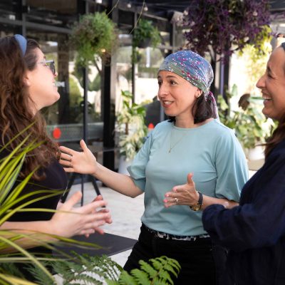 Three Women Talking in an Outdoor Space