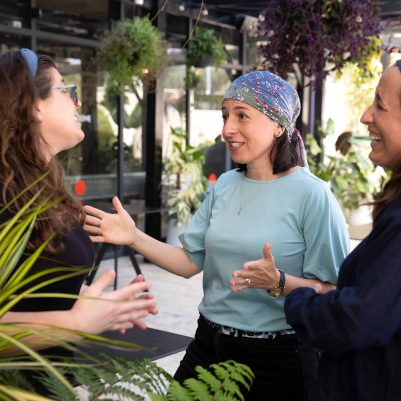Three Women Talking in an Outdoor Space
