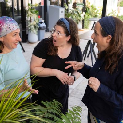 Two Women React in Shock as Their Friend Shares Surprising News